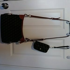 Dooney Bourke signature handbag. Adjustable strap.